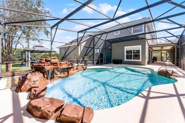 a view of patio with table and chairs under an umbrella