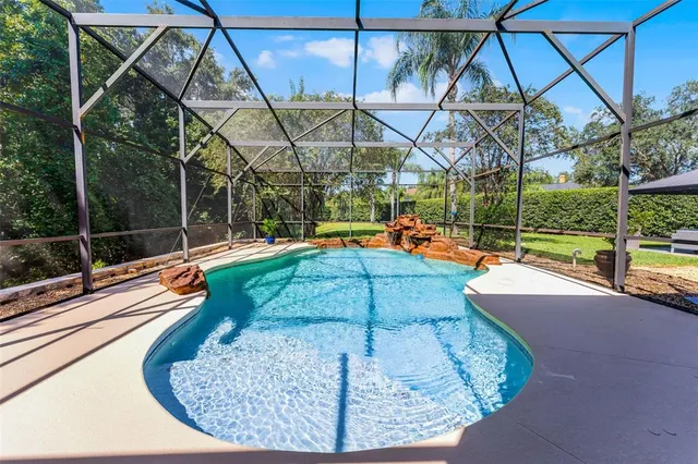 a view of a backyard with swimming pool