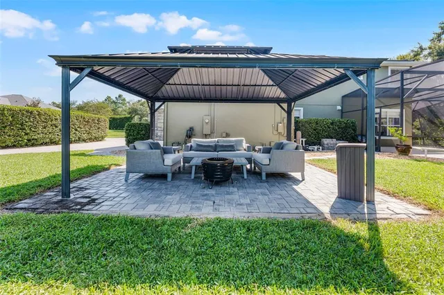a swimming pool with outdoor seating and yard