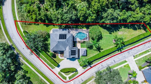 an aerial view of residential houses with outdoor space and swimming pool