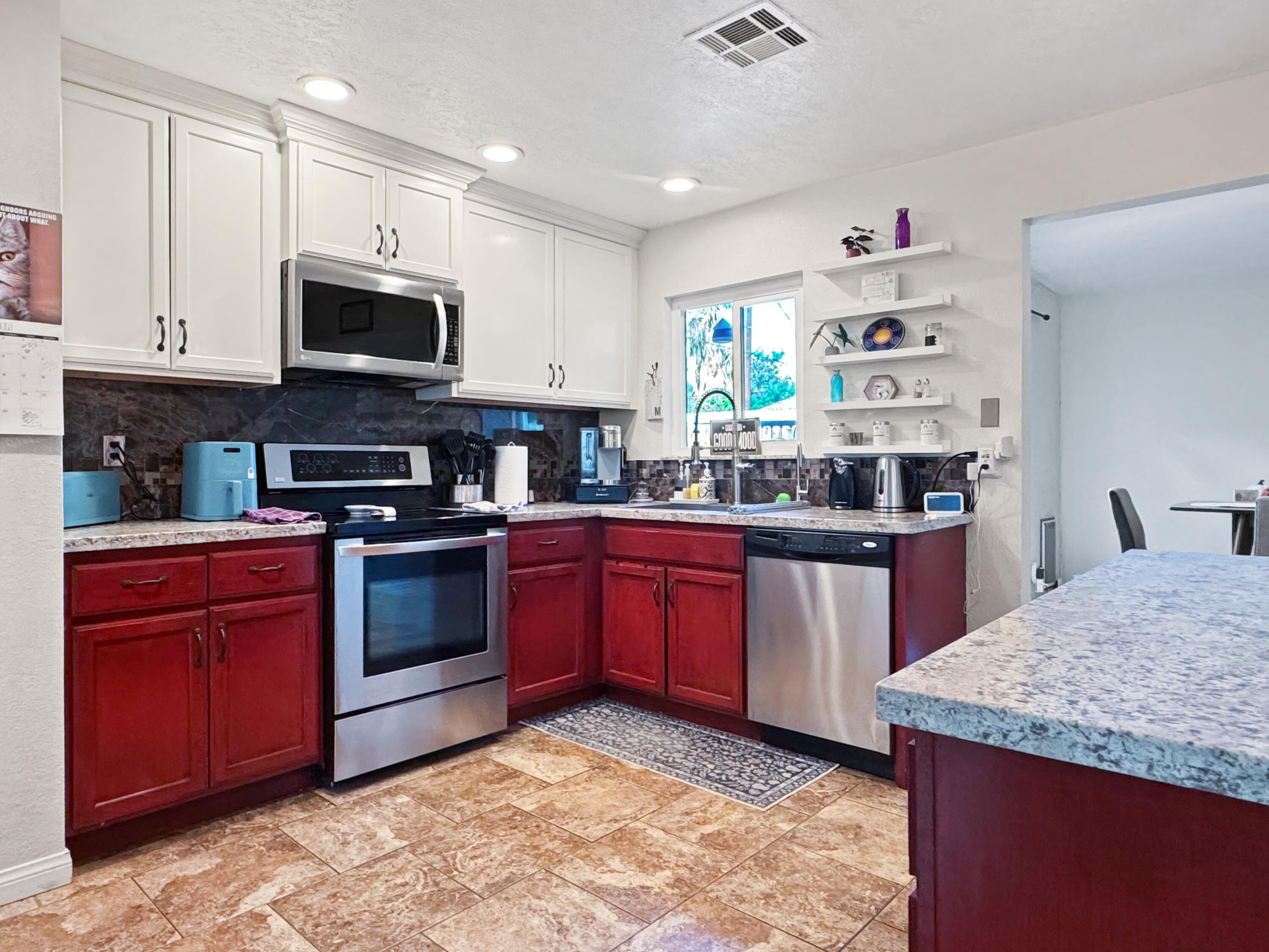 53845 Avenida Herrera La Quinta, CA 92253 - Photo 11 of 25 a kitchen with stainless steel appliances granite countertop a stove sink and microwave
