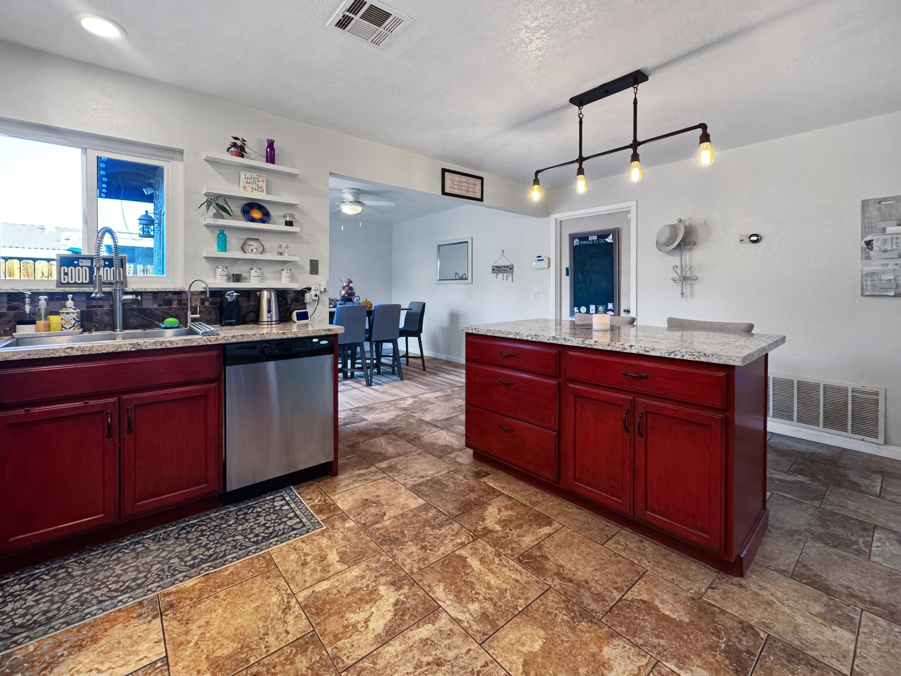 53845 Avenida Herrera La Quinta, CA 92253 - Photo 12 of 25 a kitchen with stainless steel appliances granite countertop sink a stove a dining table and chairs