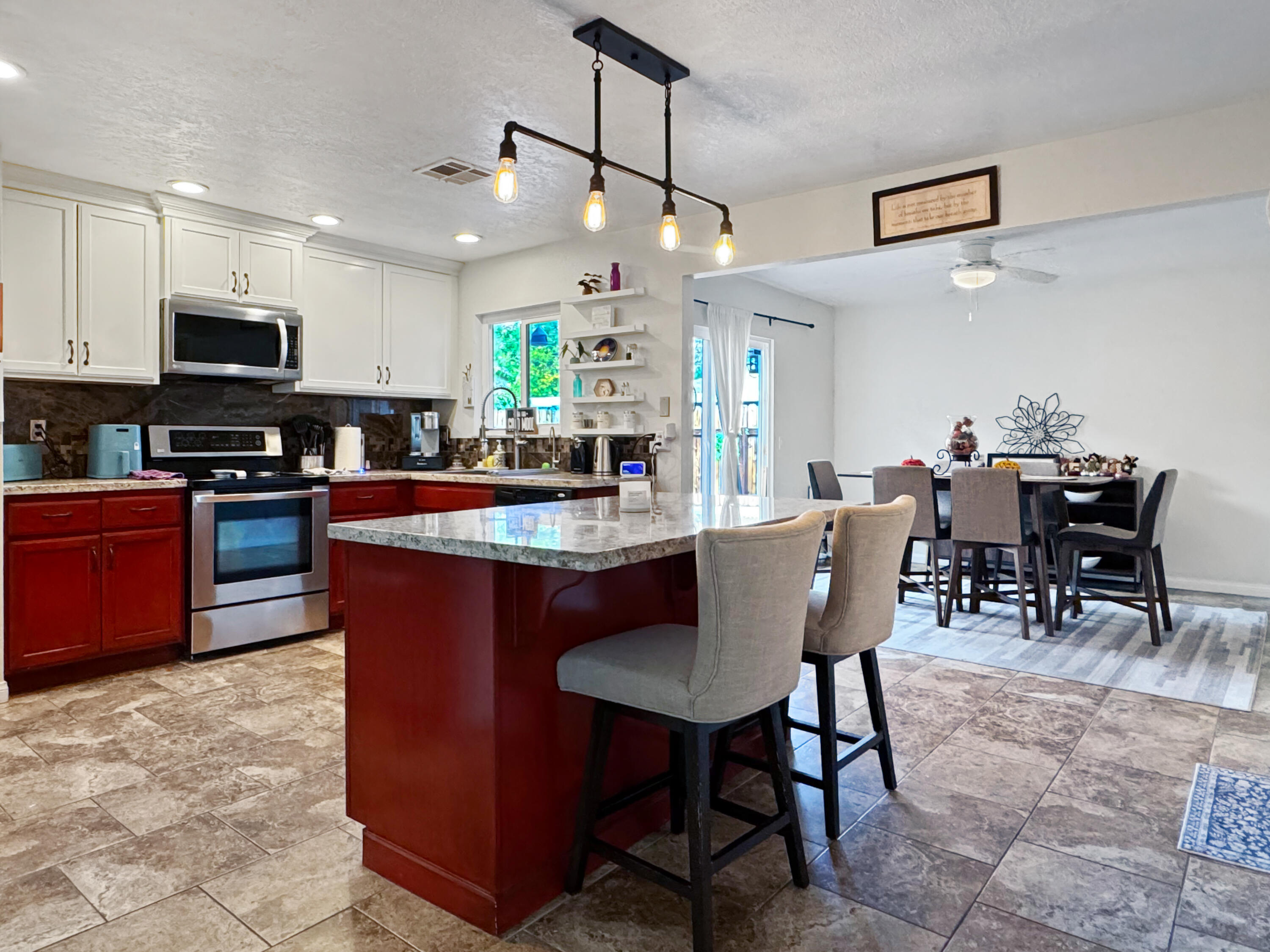 53845 Avenida Herrera La Quinta, CA 92253 - Photo 13 of 25 a large kitchen with kitchen island a dining table and chairs