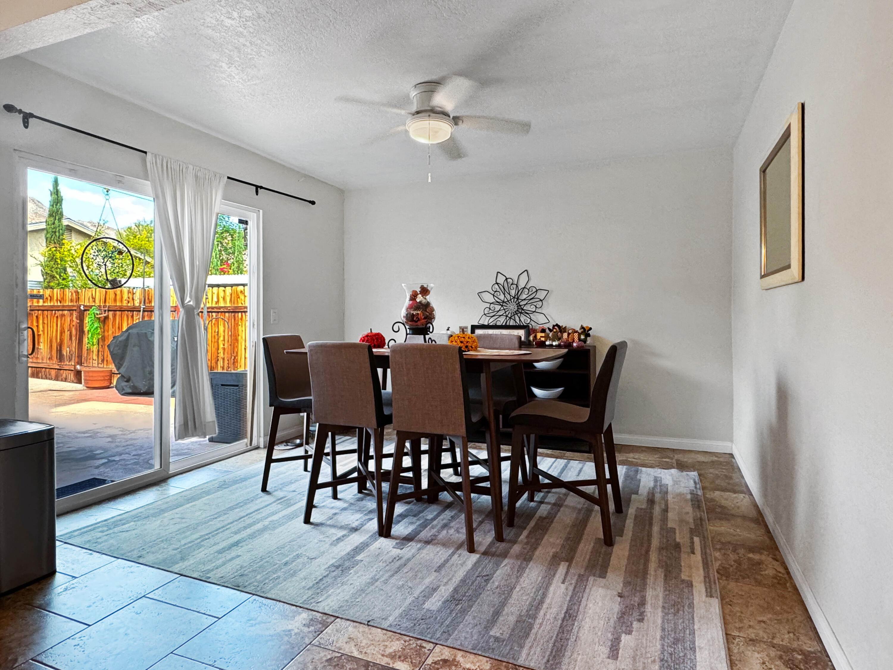 53845 Avenida Herrera La Quinta, CA 92253 - Photo 14 of 25 a dining room with furniture a rug and a floor to ceiling window