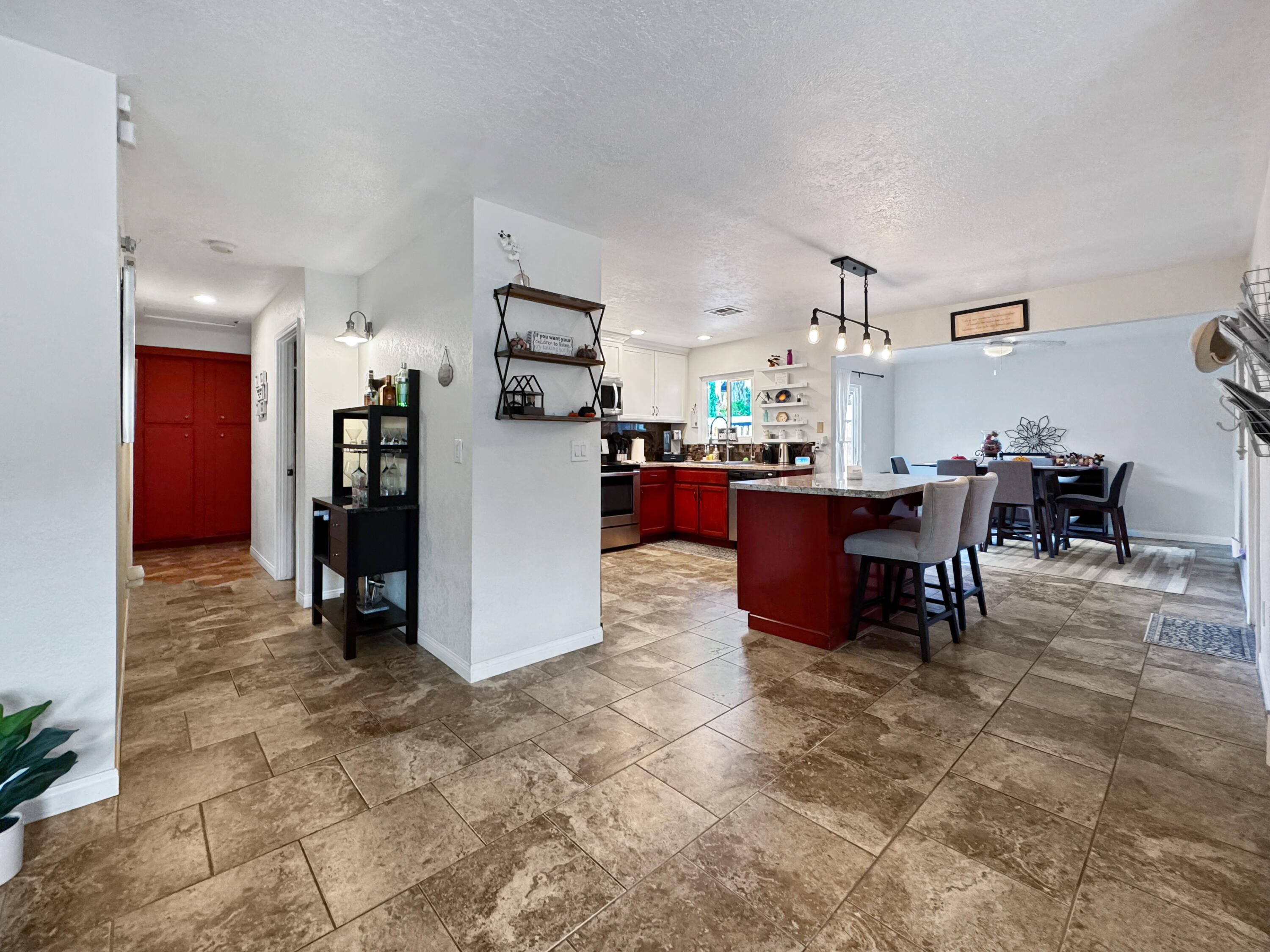 53845 Avenida Herrera La Quinta, CA 92253 - Photo 16 of 25 a room with stainless steel appliances kitchen island granite countertop a refrigerator and a dining table