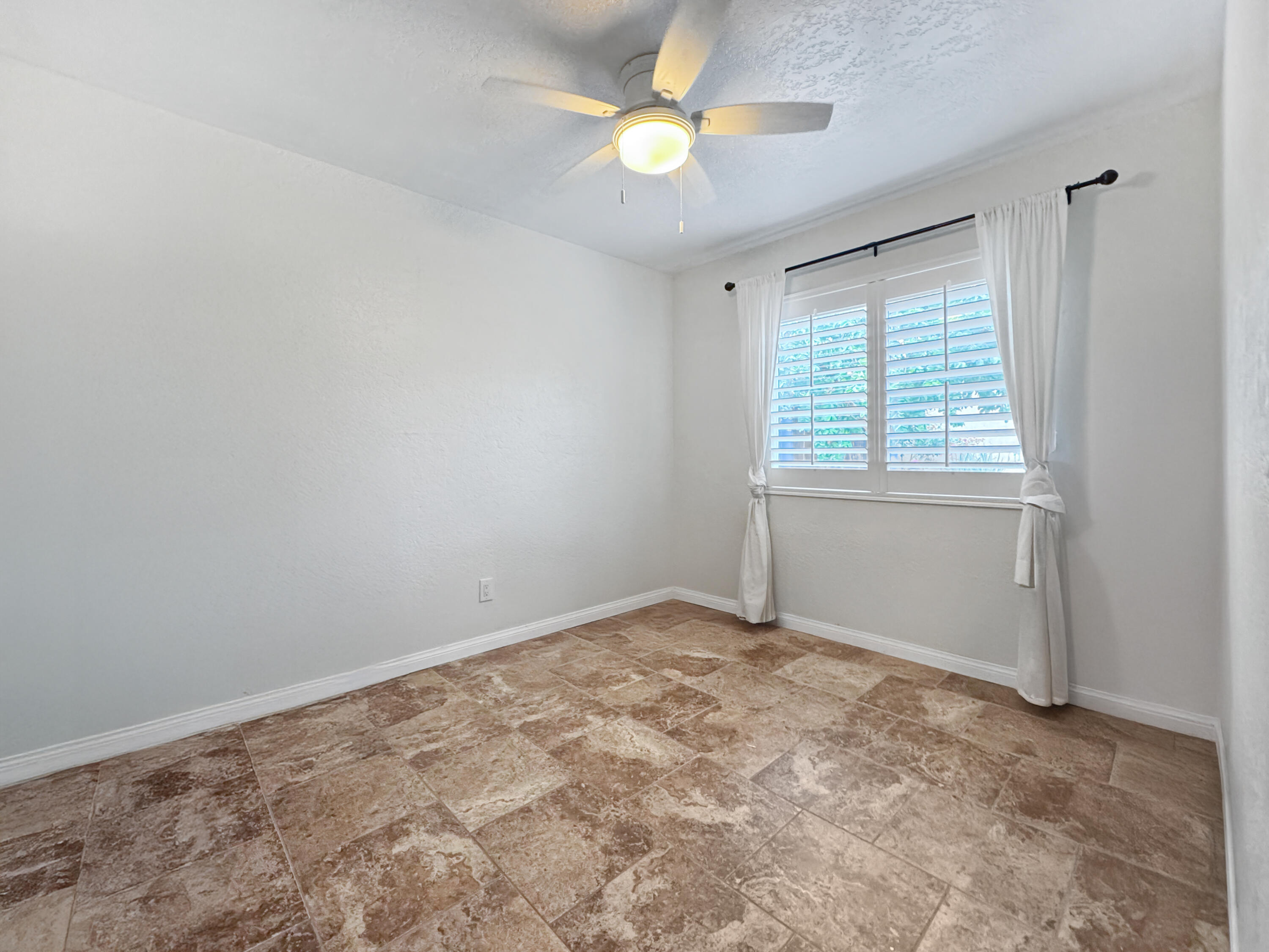 53845 Avenida Herrera La Quinta, CA 92253 - Photo 20 of 25 an empty room with a window and a fan