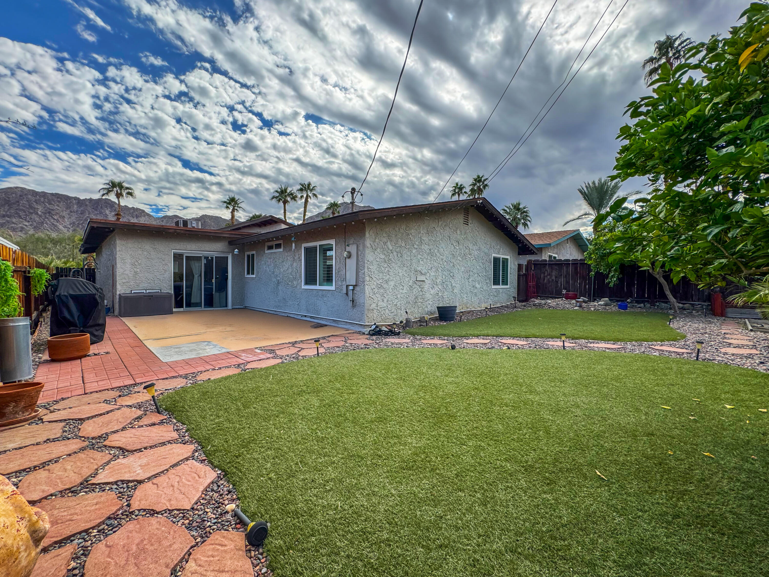 53845 Avenida Herrera La Quinta, CA 92253 - Photo 23 of 25 a front view of a house with yard and green space
