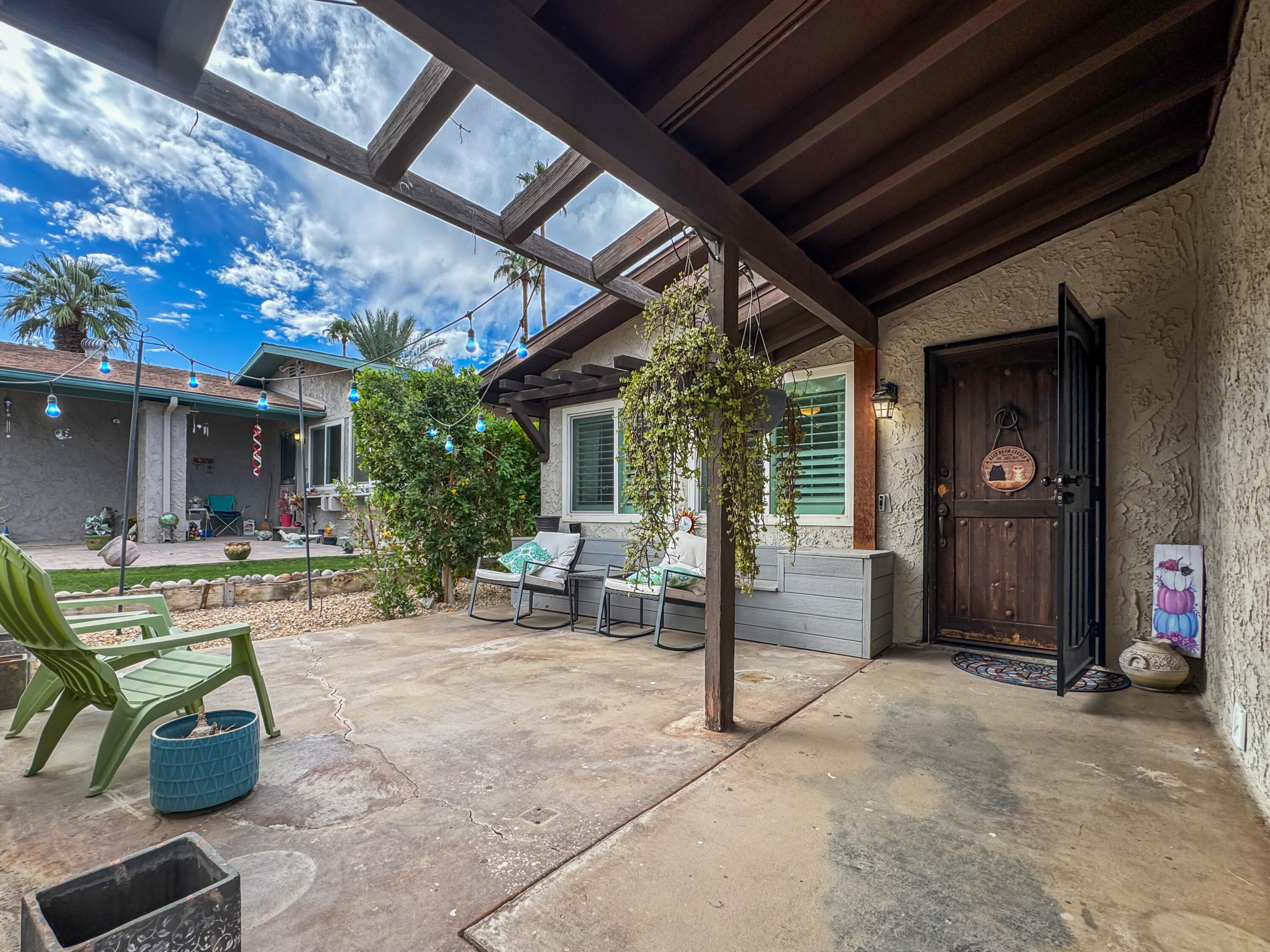53845 Avenida Herrera La Quinta, CA 92253 - Photo 3 of 25 a view of a patio with table and chairs and potted plants