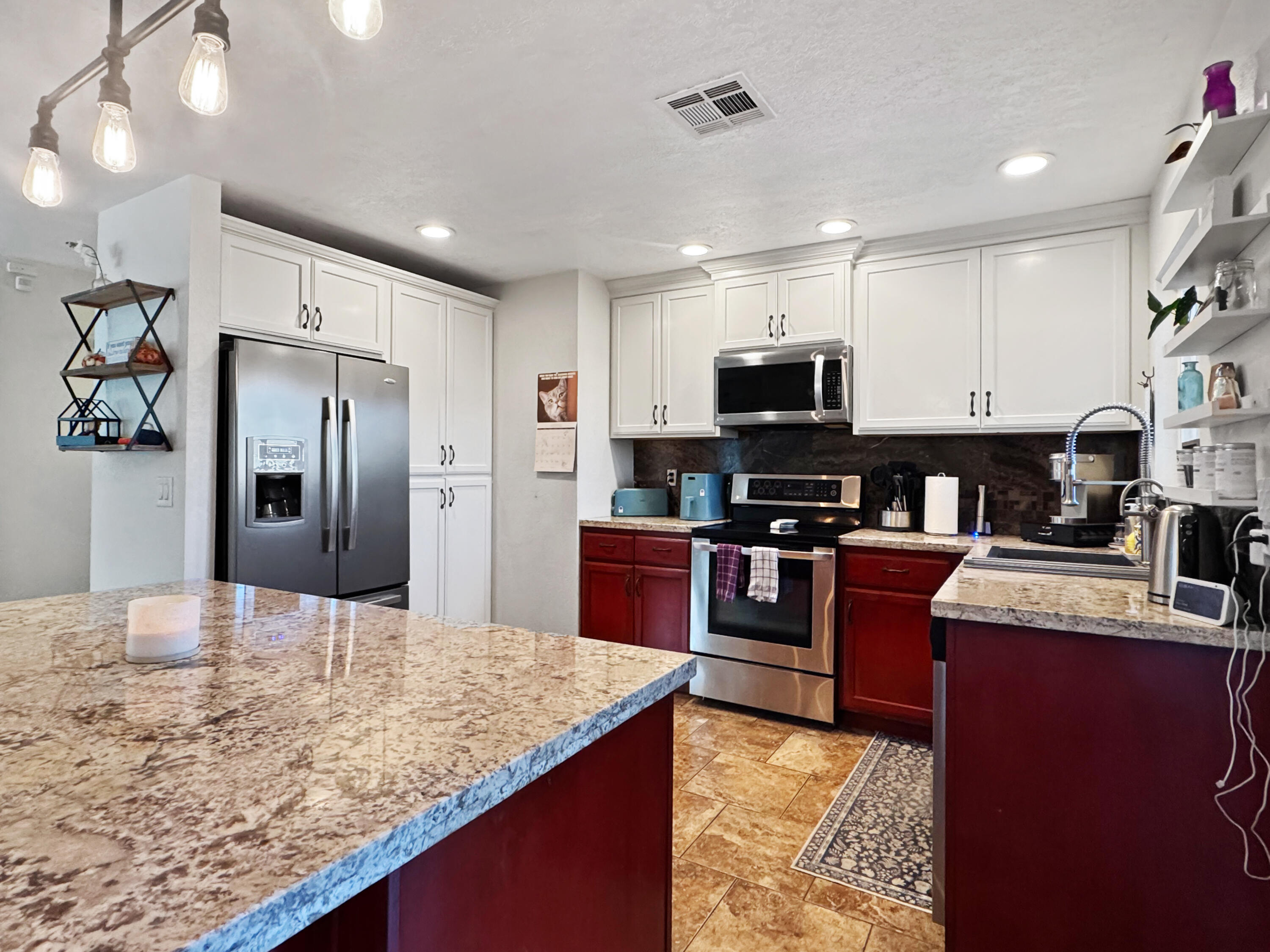 53845 Avenida Herrera La Quinta, CA 92253 - Photo 9 of 25 a kitchen with stainless steel appliances granite countertop a refrigerator stove microwave and sink