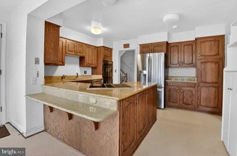 a kitchen with stainless steel appliances a sink stove and refrigerator