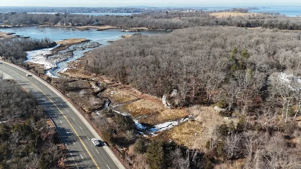 a view of a balcony with chairs and wooden floor