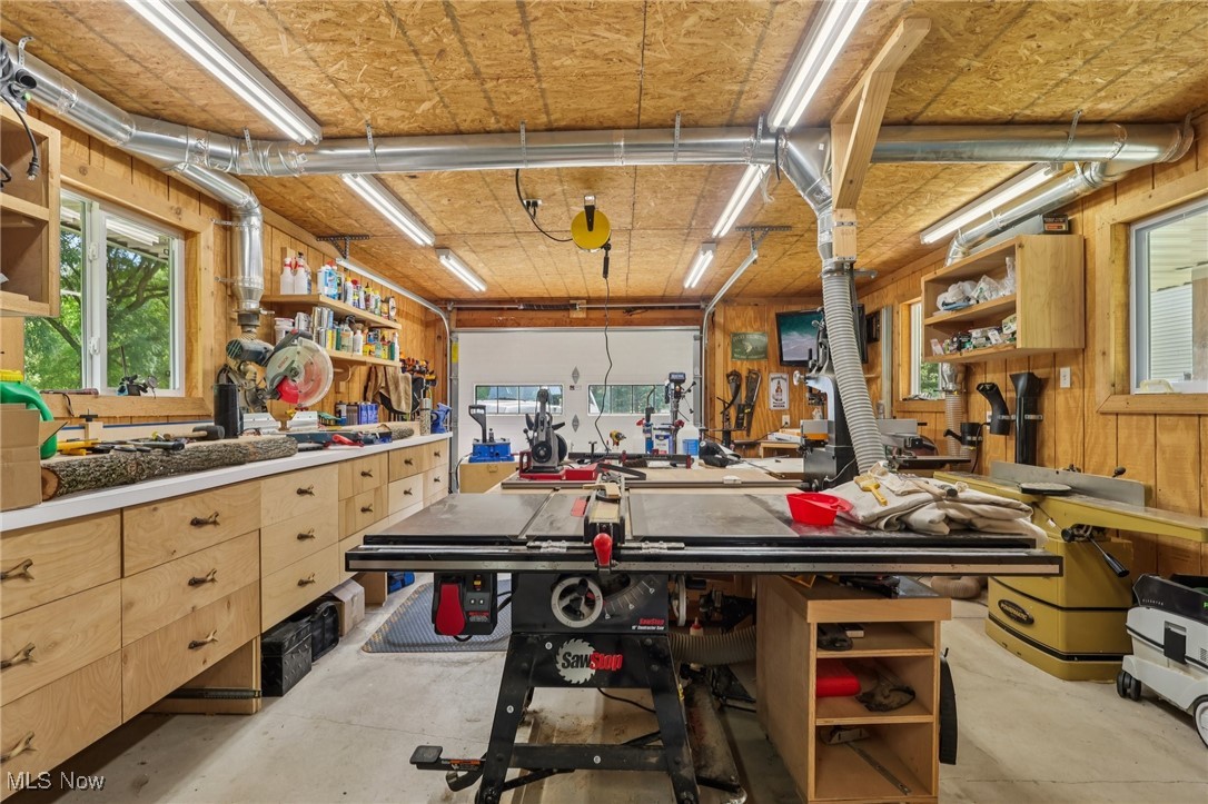 230 South Medina Line Road Akron, OH 44321 - Photo 43 of 50 Garage with a workshop area and wood walls