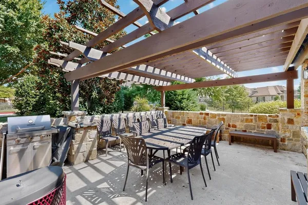 a kitchen with granite countertop stainless steel appliances a refrigerator stove top oven and sink