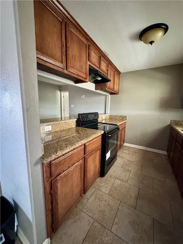 a kitchen with stainless steel appliances granite countertop a stove and a sink