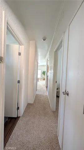 a view of a hallway with wooden shelves