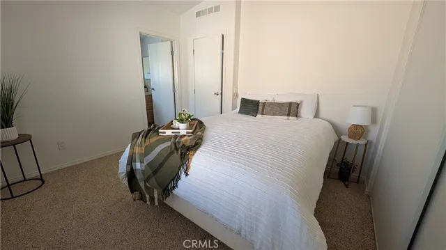 a bedroom with a bed and a mirror