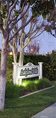 a view of sign board with tall buildings