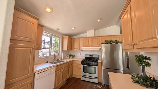 a kitchen with stainless steel appliances a refrigerator sink and cabinets