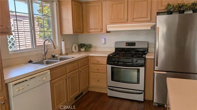 a kitchen with sink cabinets and appliances