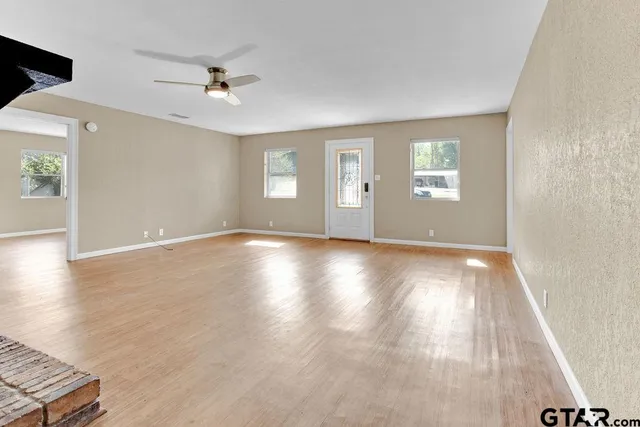 wooden floor in an empty room with a window