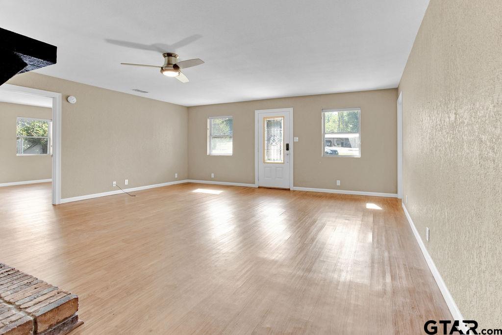 213 Treetop Lane Hideaway, TX 75771 - Photo 11 of 48 wooden floor in an empty room with a window