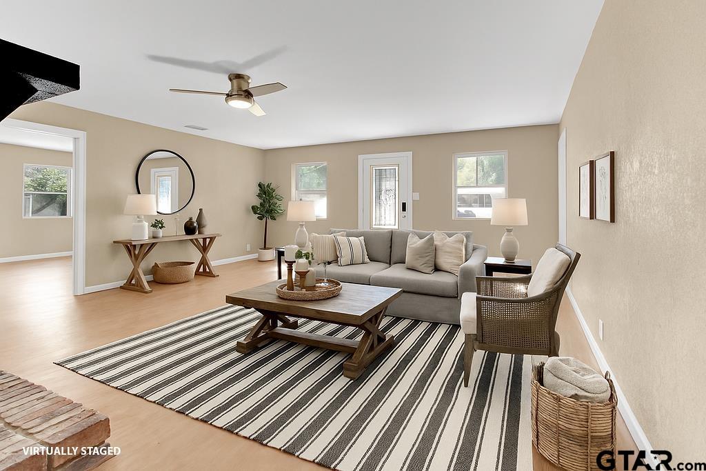 213 Treetop Lane Hideaway, TX 75771 - Photo 12 of 48 a living room with furniture a table and a large mirror