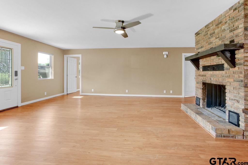213 Treetop Lane Hideaway, TX 75771 - Photo 13 of 48 an empty room with windows and a fireplace