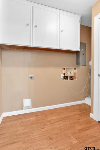 a view of room with cabinets and a wooden floor