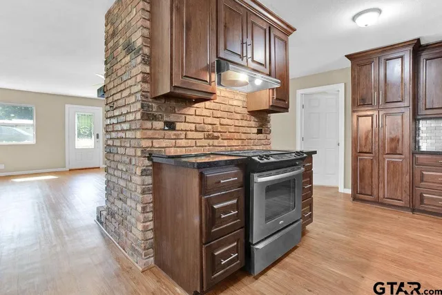 a kitchen with stainless steel appliances granite countertop a stove and a refrigerator