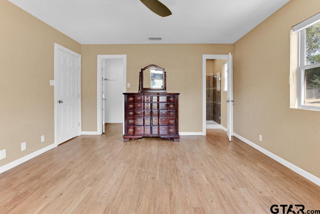 213 Treetop Lane Hideaway, TX 75771 - Photo 24 of 48 an empty room with wooden floor closet and windows