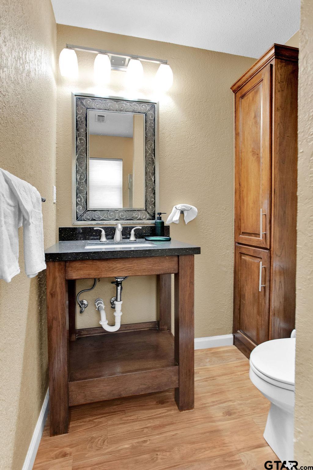 213 Treetop Lane Hideaway, TX 75771 - Photo 26 of 48 a bathroom with a sink a toilet and shower