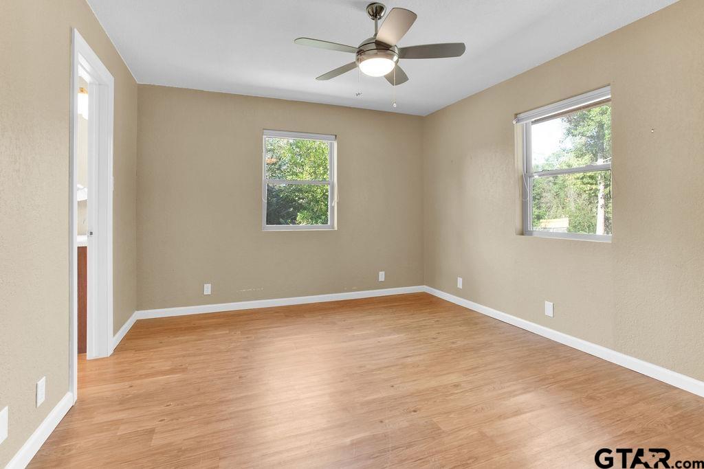 213 Treetop Lane Hideaway, TX 75771 - Photo 28 of 48 a view of an empty room with a window and wooden floor