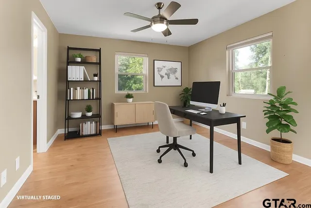 a workspace with wooden floor and a window
