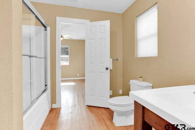 a bathroom with a sink a toilet and shower