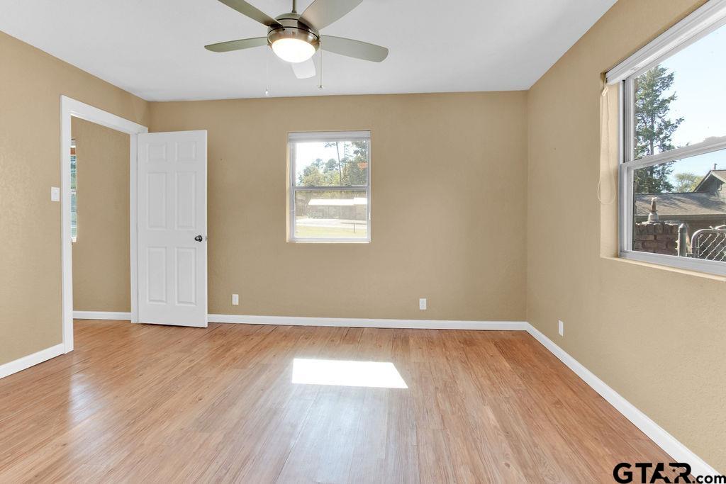 213 Treetop Lane Hideaway, TX 75771 - Photo 33 of 48 a view of an empty room with wooden floor and a window
