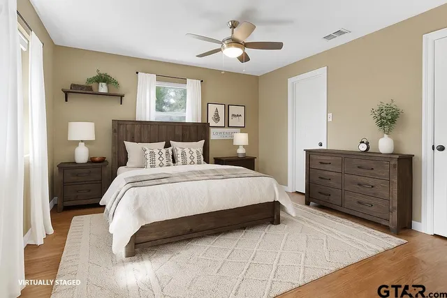 a bedroom with a large bed and a dresser