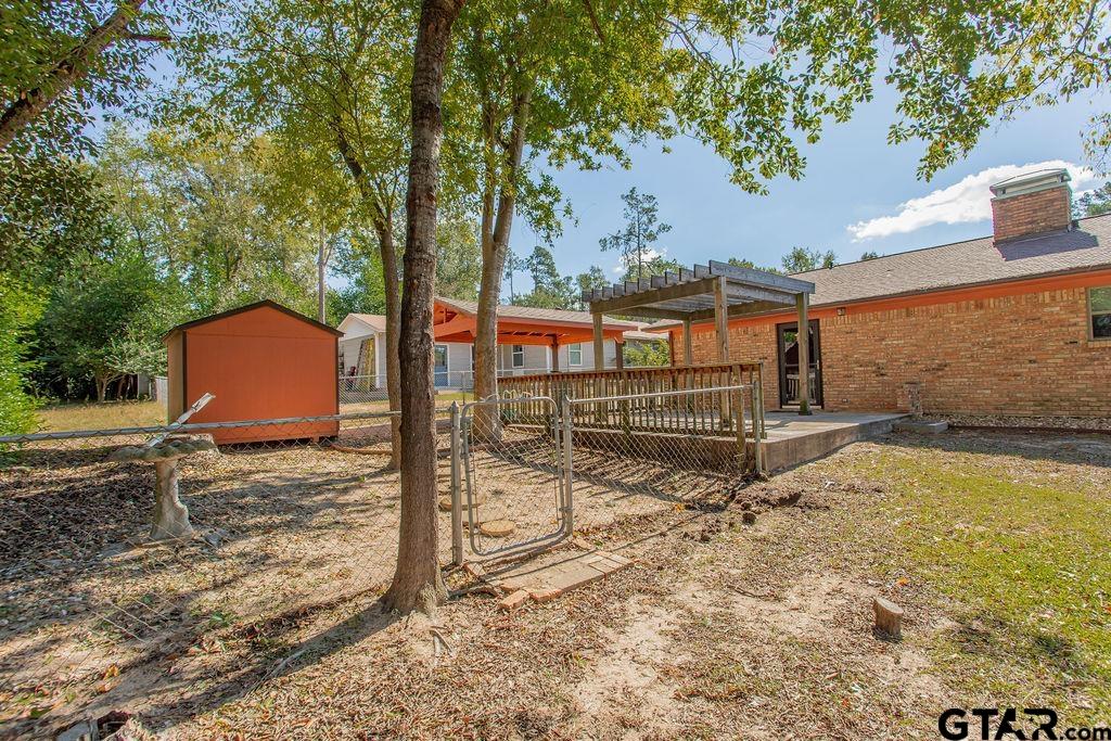 213 Treetop Lane Hideaway, TX 75771 - Photo 41 of 48 a backyard of a house with a yard and outdoor seating