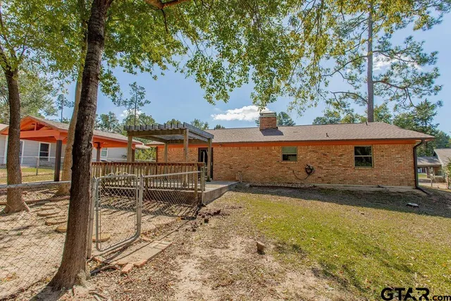 a backyard of a house with barbeque oven tree and table