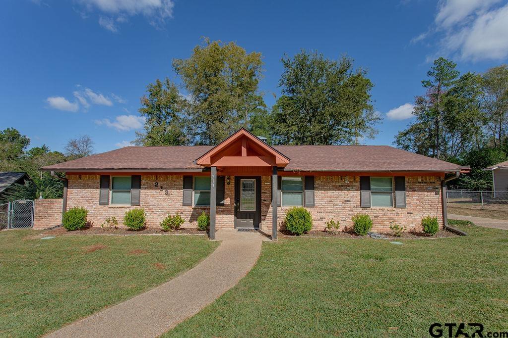 213 Treetop Lane Hideaway, TX 75771 - Photo 8 of 48 a front view of a house with garden