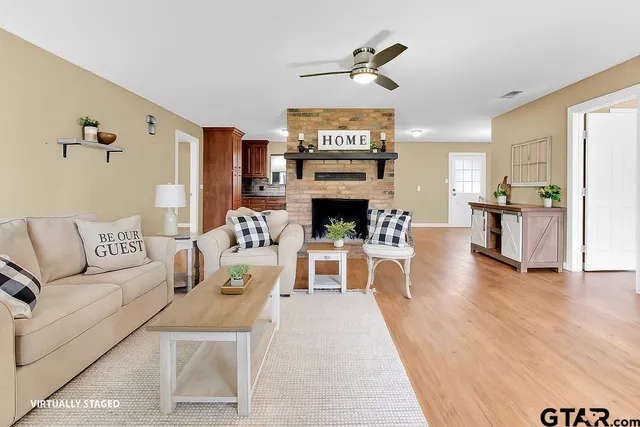 a living room with furniture and a fireplace