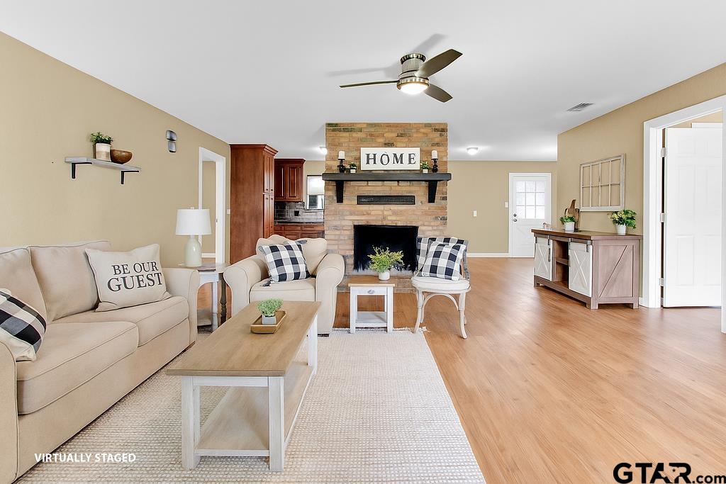 213 Treetop Lane Hideaway, TX 75771 - Photo 10 of 48 a living room with furniture and a fireplace