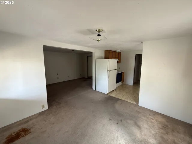 a view of a kitchen with a sink and a refrigerator