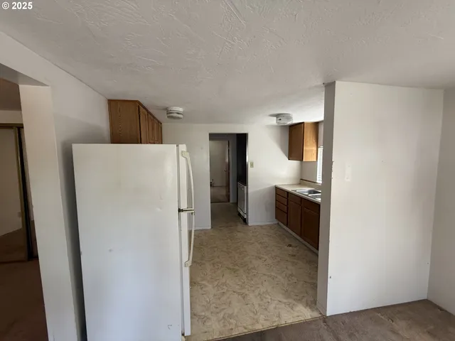 a kitchen with a refrigerator and a stove