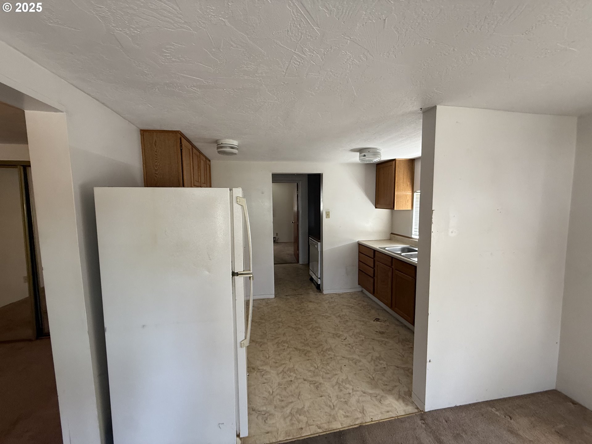 410 Birch Street Drain, OR 97435 - Photo 5 of 14 a kitchen with a refrigerator and a stove