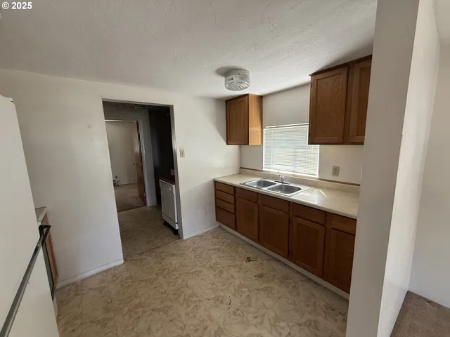 a spacious bathroom with a sink and a mirror
