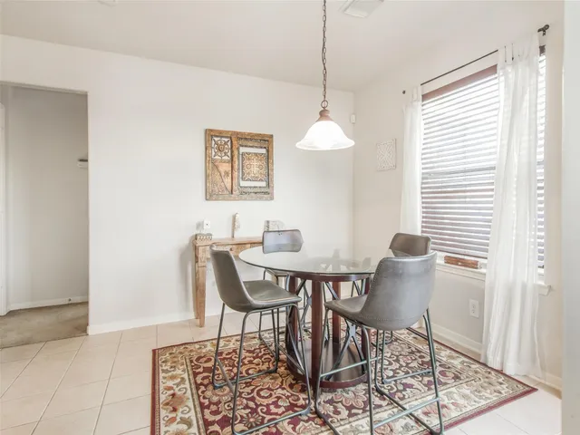 a view of a dining room with furniture and a window