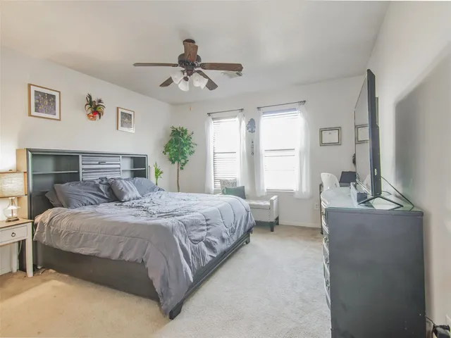 a bedroom with a large bed and window