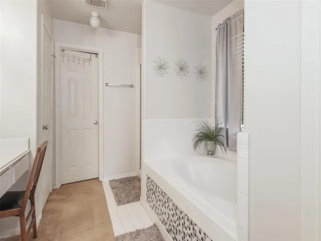a bathroom with a bathtub and shower