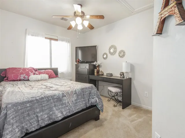 a bedroom with a bed and a chandelier