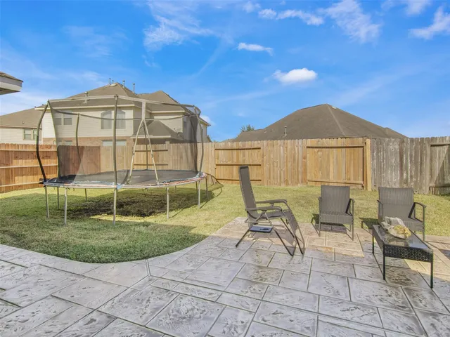 a view of a house with backyard porch and sitting area